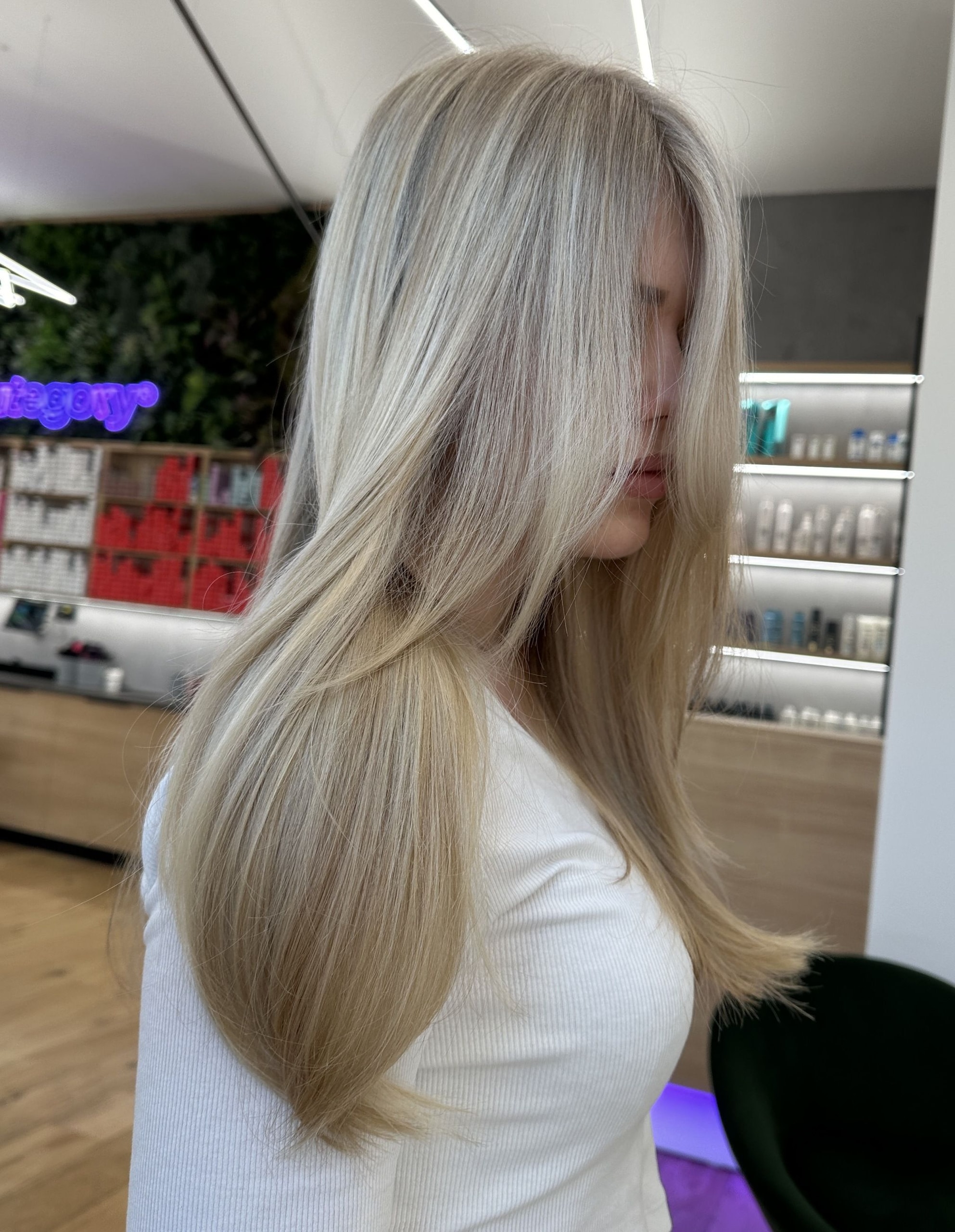 Airtouch se střihem: dlouhé rovné platinově blond vlasy s delší ofinou podél obličeje, foceno v salonu (Klára Valnerová)