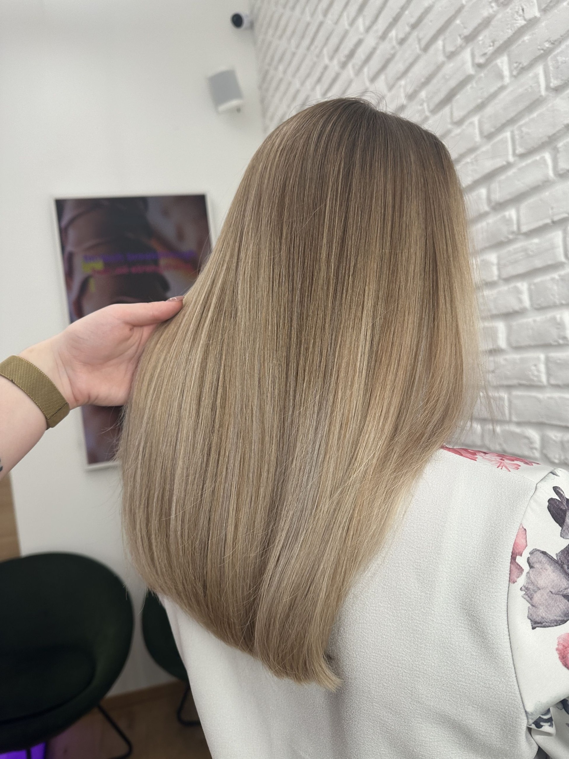 Airtouch se střihem: rovné vlasy po lopatky v blond barvě s tmavším kořínkem, ruka ve vlasech (Klára Valnerová)